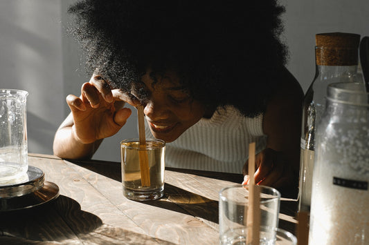 A woman smelling a CBD infused candle