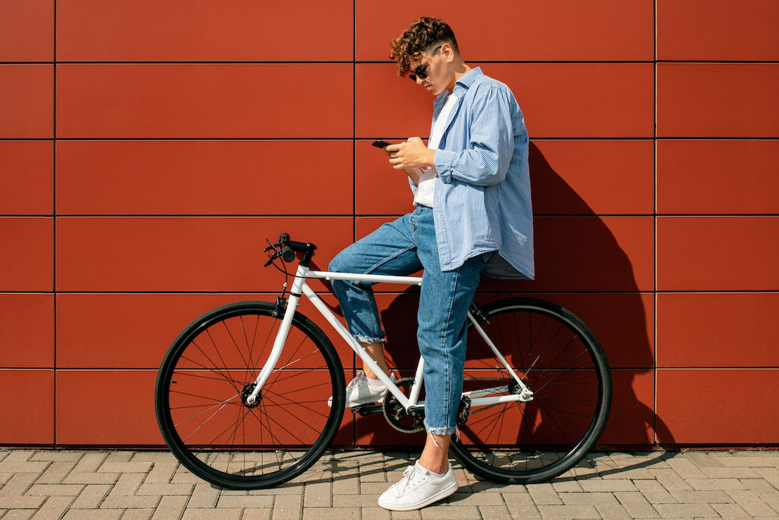 A man on his bike using his cellphone to look up CBD facts